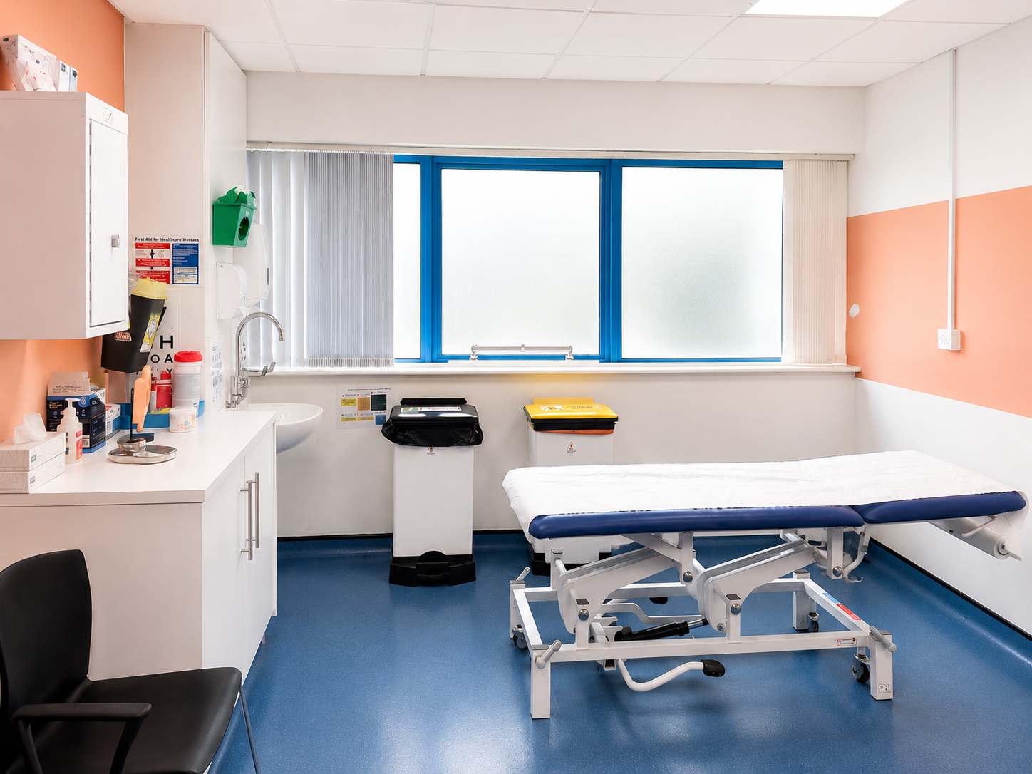 Clean acupuncture treatment room with a blue treatment couch at the Stockport clinic.